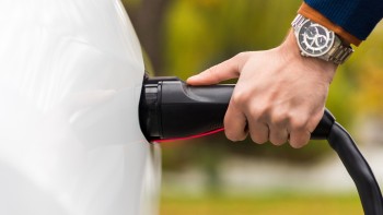 close-view-man-plugging-charger-into-electric-car-charging-port (1) Experienced EV Charger Installer in Al Ain